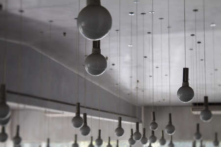 Round ceiling lamps on wires at the lighting storeの写真素材