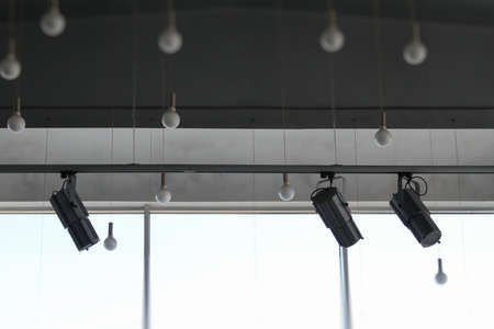 Lighting technology in studio with moving track spotlights and ceiling lampsの写真素材