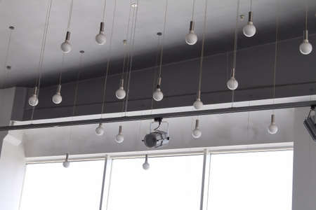 Lighting technology in studio with moving track spotlights and ceiling lampsの写真素材