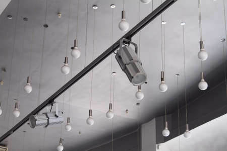 Lighting technology in studio with moving track spotlights and ceiling lampsの写真素材