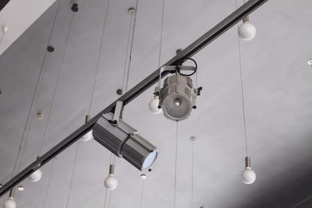 Lighting technology in studio with moving track spotlights and ceiling lampsの写真素材