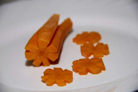 Carrot sliced in the form of stars on white plate. Macro shotの写真素材