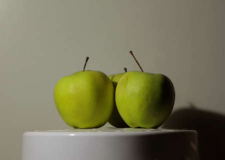 Fresh green apples on white plate studio isolatedの写真素材