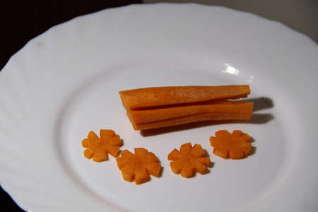 Carrot sliced in the form of stars on white plate. Macro shotの写真素材