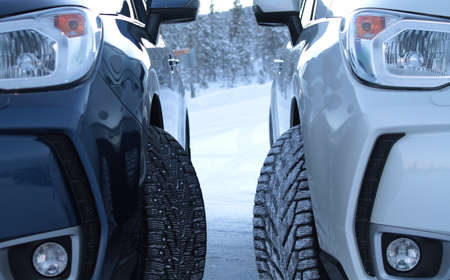 Winter drive safety. Studded tires against non-studded tiresの写真素材