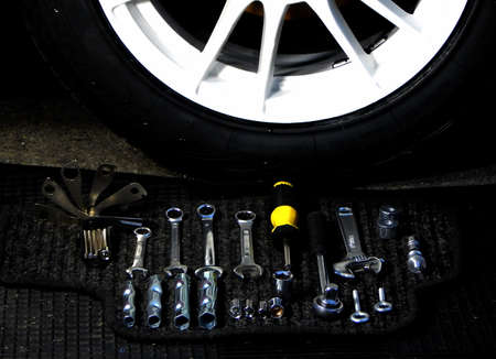 Tools kit for car disk mounting near car wheel at car workshopの写真素材
