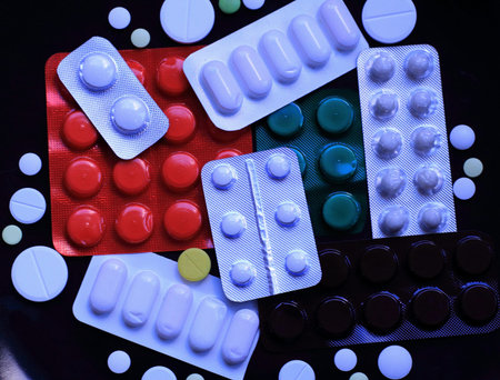 Blisters of pills and scattered tablets studio isolated
