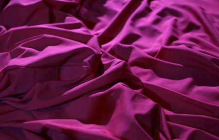 Bed linen shop. Wrinkles on the red silk vail detailed stock imageの写真素材
