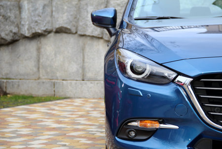 Blue car parking on paving stones at walking area stock photo