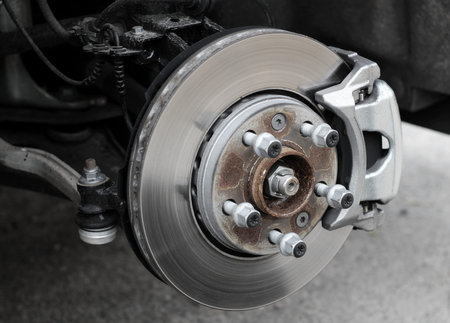 Brake service inspection. Damaged brake disc and pads on classic vehicle