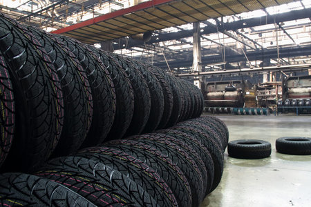 Tires production plant site. New cars tires stacking up on the workshop floorの写真素材