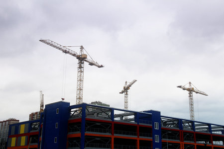 Crane Works Over Concrete Frame Of New Building