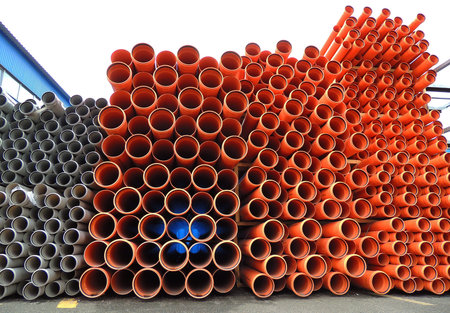 Variety PVC Pipes Stacked in Warehouse