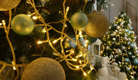 Lights Of Garland On A Pine Tree With Christmas Balls And Another Pine Tree With New Year Gifts On...