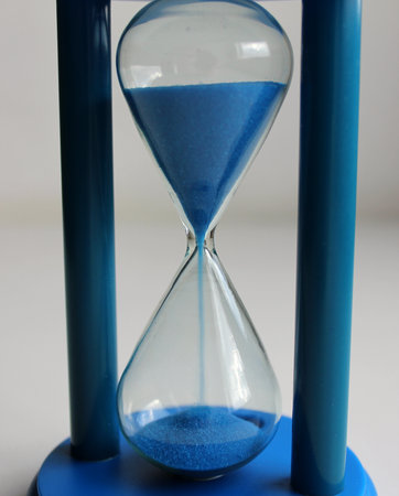 Blue Sand Flows Down In A Colored Sandglass Detailed Stock Photoの写真素材