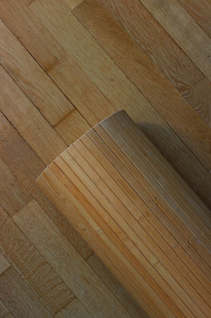 Bamboo Paneling Roll On A Wooden Planks Texture Backgroundの写真素材