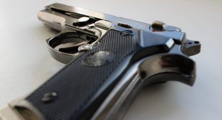 The back side of the grooved pistol grip with the hammer not cocked