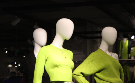 A group of mannequins in women's clothing near the showcases with a new collectionの写真素材