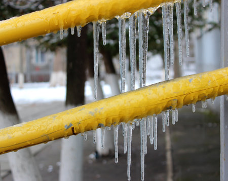 Icy handrails with frozen icicles near the entrance to a private houseの写真素材