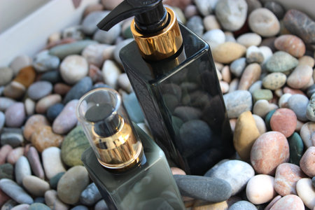 Body care products in a spa salon on a stand with decorative pebblesの写真素材