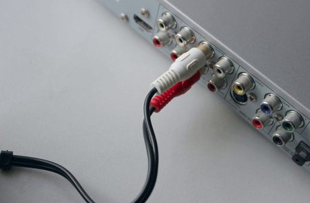 Top view of a video cable connected to two channels of player with different colors RCA plugs