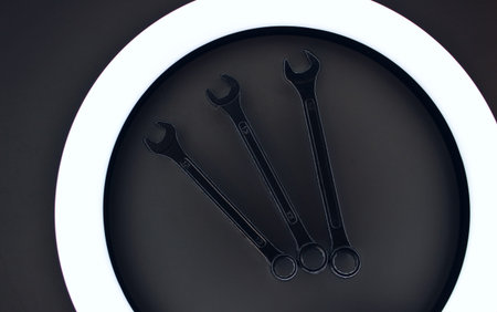 Arranged By Numbers Three Wrenches Inside Ring Lamp On White Workbench
