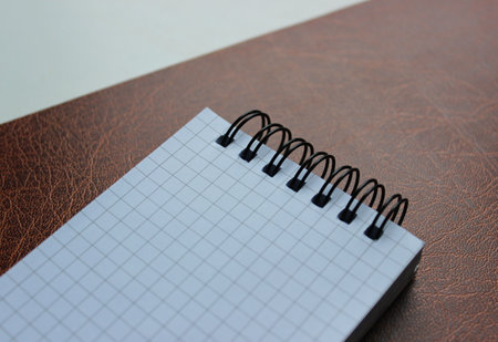 Beginnings And Ideas Concept. Leather Paper Folder With Clean Checkered Binder Notepadの写真素材