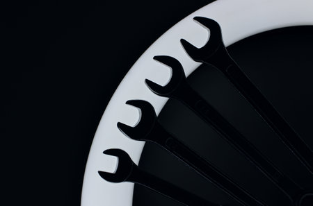 Silhouettes Of Steel Spanners Laid Out In Line On Ring Light In Darknessの写真素材