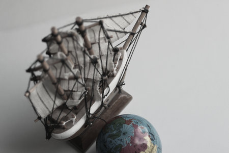 Sea Travel Concept Image. Globe And Wooden Model Of Old Ship In Muted Colors Styleの写真素材