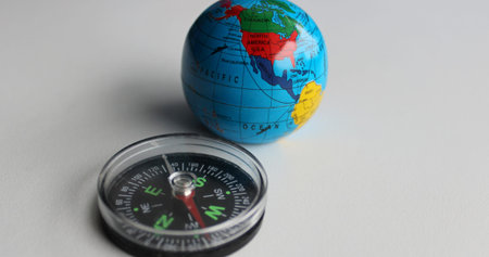 Vintage Compass And Earth Sphere Lying On White Surface Studio Isolated