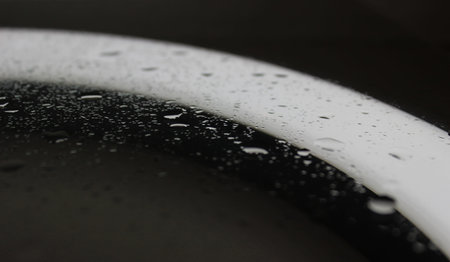 Sprinkled Water Drops On Clean Illuminated Glass After Repellent Coating Macro Shot Stock Photo