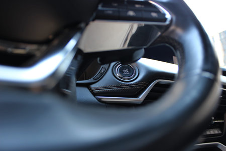Leather Trimming And Upholstery Of Car Panel With Start Engine Button Is Visible Through Defocused...