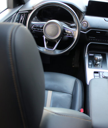 View From Driver Headrest on the Instrument Cluster and Steering Wheel Inside A Car. Switched Off...