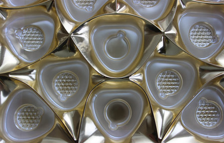 Golden Plastic Candy Divider Tray Top View. Pattern of Empty Cells Of Candy Box