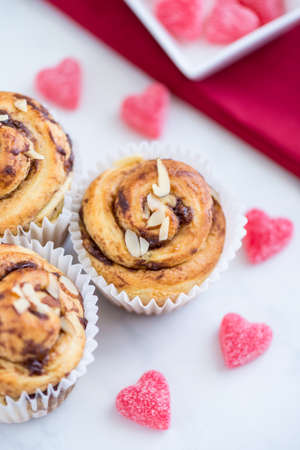 Muffins with Red Napkin and Square Dish with Candy Heartsの写真素材