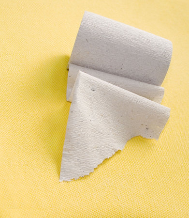 Roll of a paper for a toilet on a yellow backgroundの写真素材