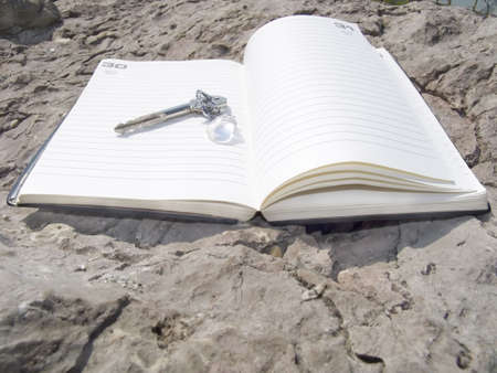 The book for records and keys from a house on a stone backgroundの写真素材