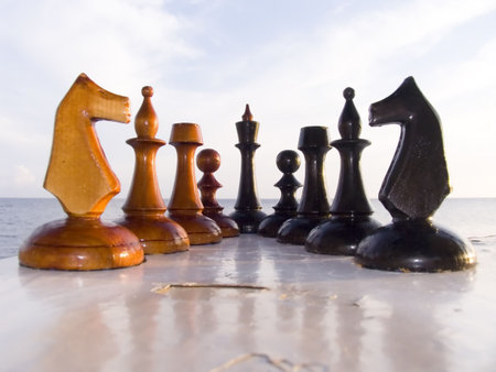 Combination from chessmen on a table with a kind on the sea