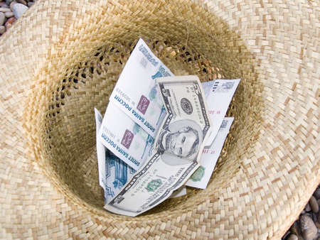 Money in a straw hatの写真素材