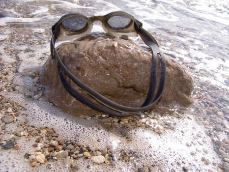 Glasses for navigation on a sea beachの写真素材