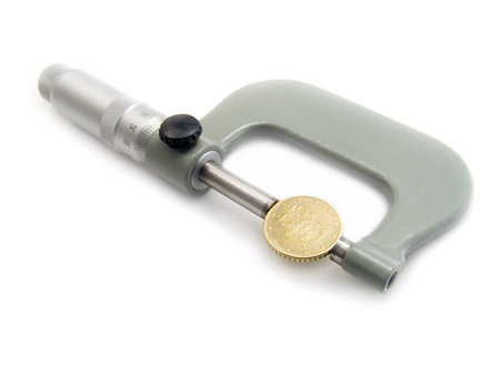 The micrometer measures Euro a coin. The concept of accuracy and quality. Isolated on a white...