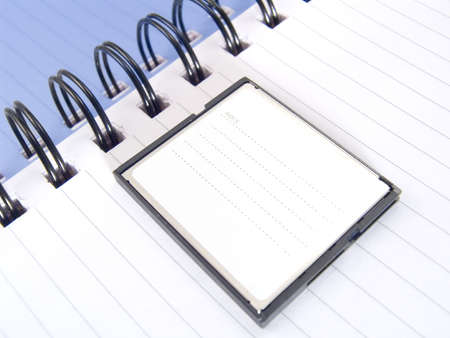 Page of a notebook with compactflash for storage of the information on the camera.  COPYSPACE - a place for accommodation of advertising in a photo.の写真素材