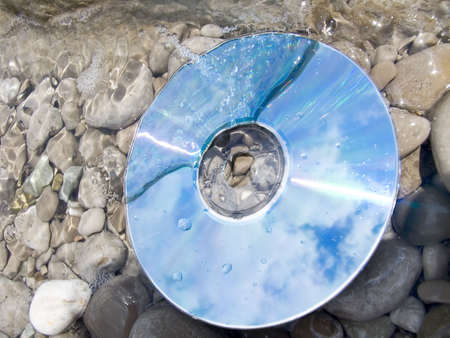 Reflection of clouds in a computer disk at coastの写真素材