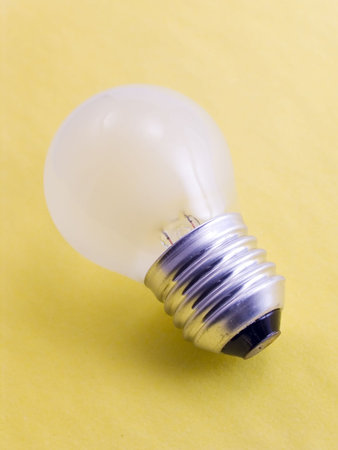 Electric bulb with a shadow on a yellow background