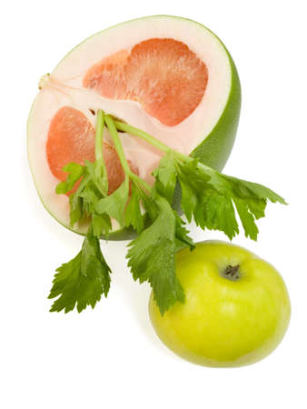 Apple green leaves of a celery and a part pummelo on a white background isolatedの写真素材