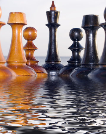Combination from chessmen on a table with a kind on the sea. Pool on forward and a backgroundの写真素材