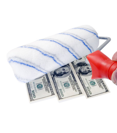 roller brush draws the American dollars on a white wall の写真素材