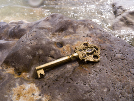 Key on a wet stone on seacoastの写真素材