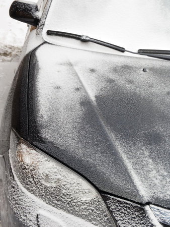 The black automobile in snow in the winterの写真素材