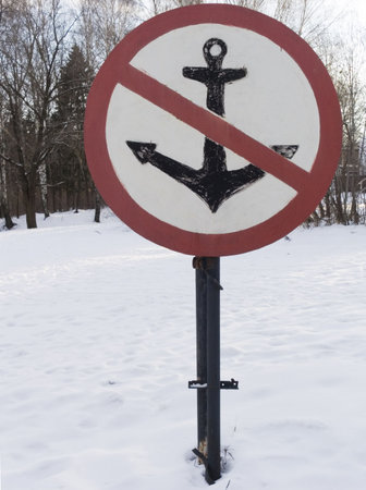 sign no anchor on the river coast in the winter